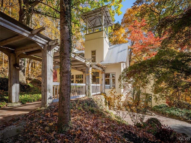 rear view of house featuring a porch