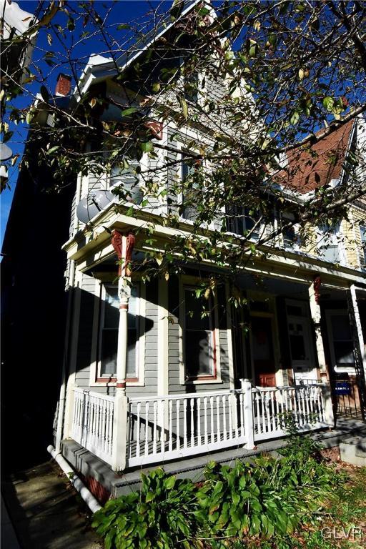 view of side of home with a porch