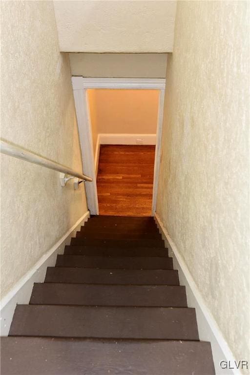 stairway featuring hardwood / wood-style flooring