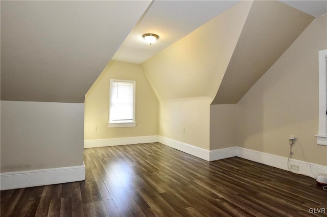 bonus room featuring dark wood-type flooring and vaulted ceiling