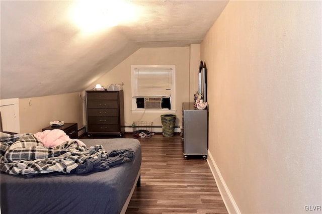 bedroom with vaulted ceiling, a baseboard radiator, and dark hardwood / wood-style flooring