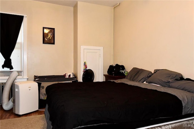 bedroom with dark hardwood / wood-style flooring