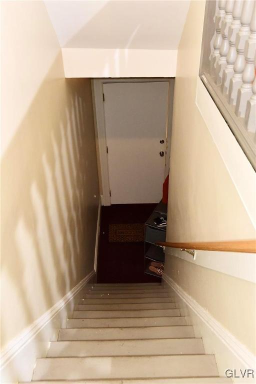 stairs featuring hardwood / wood-style floors