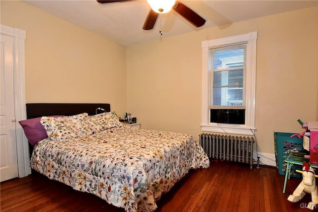 bedroom featuring ceiling fan, radiator, and dark hardwood / wood-style flooring