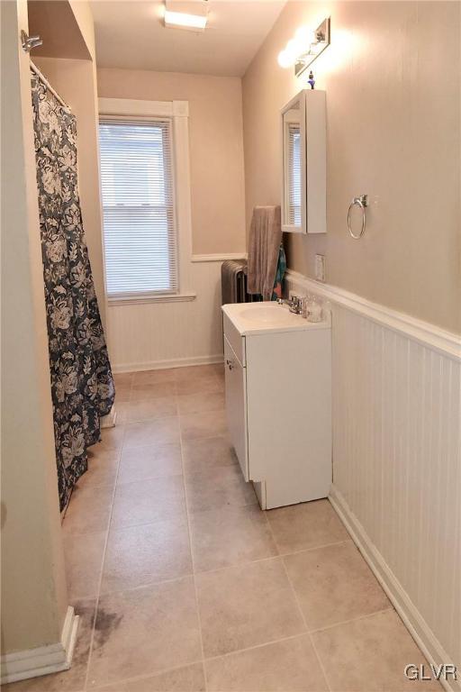 bathroom with tile patterned flooring and vanity