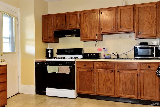 kitchen featuring sink and white stove