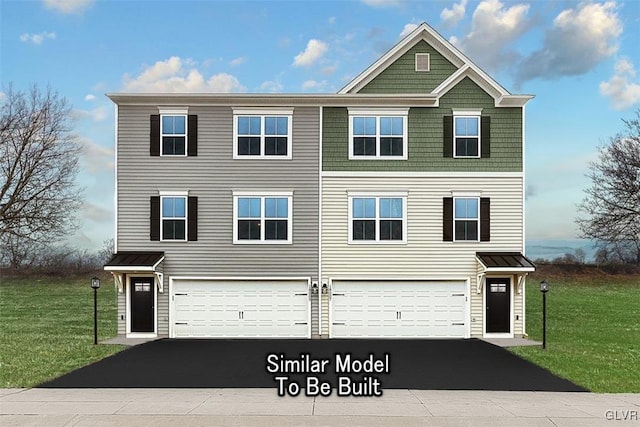 view of front of house with a garage and a front yard