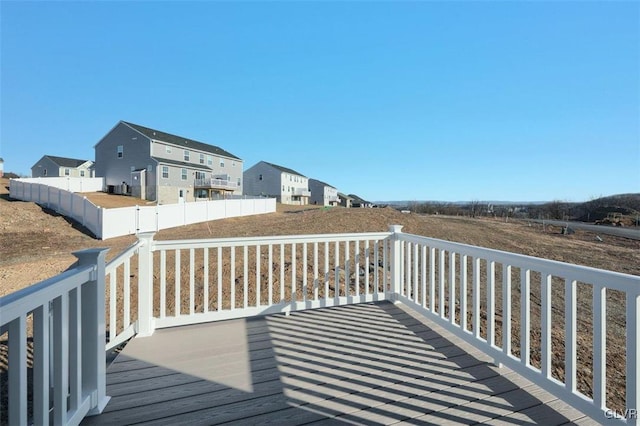 wooden terrace with fence and a residential view