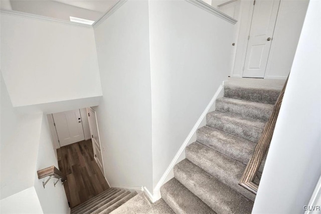 stairway featuring baseboards and wood finished floors