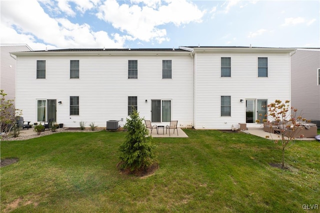 back of property featuring a yard, central AC, and a patio