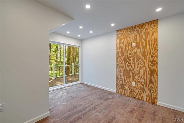 unfurnished room with hardwood / wood-style floors