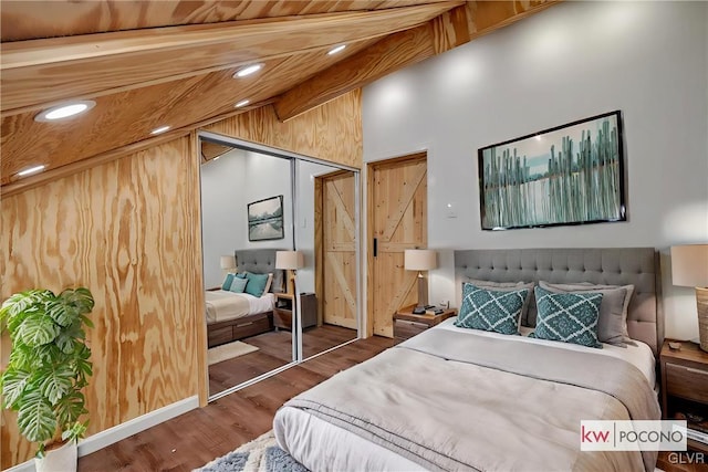 bedroom with beamed ceiling, a closet, dark hardwood / wood-style flooring, and high vaulted ceiling