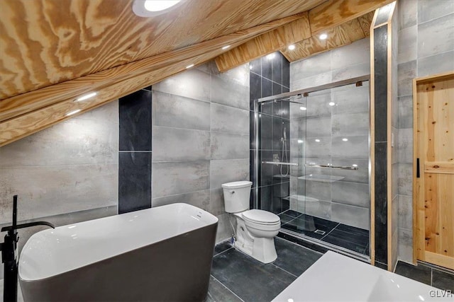 bathroom featuring vaulted ceiling, tile walls, toilet, and plus walk in shower