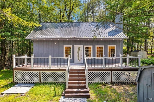 view of front of home with a storage shed and a wooden deck