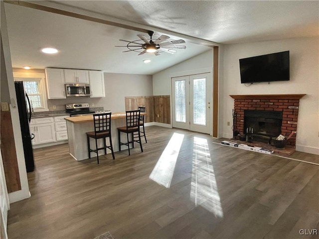 kitchen with white cabinetry, plenty of natural light, vaulted ceiling, and appliances with stainless steel finishes