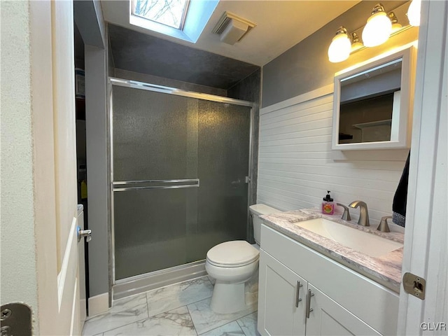 bathroom with a skylight, toilet, an enclosed shower, and wooden walls