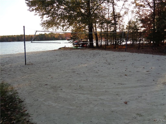 view of yard with a water view and volleyball court