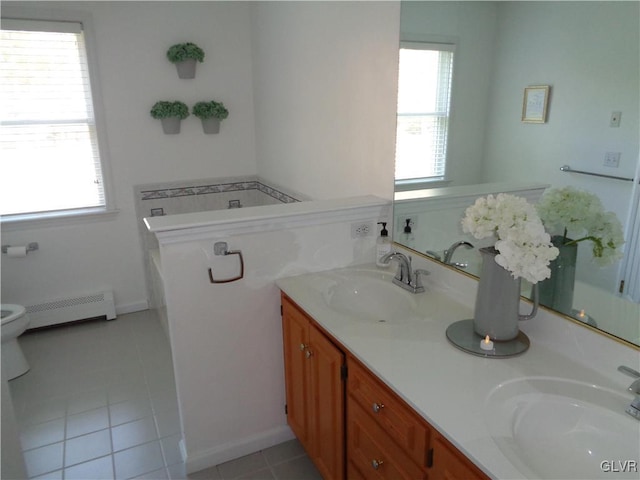 144 Dogwood Dr, Penn Forest Township, PA 18229 - full bath featuring a baseboard radiator, double vanity, tile patterned flooring, toilet, and a bath