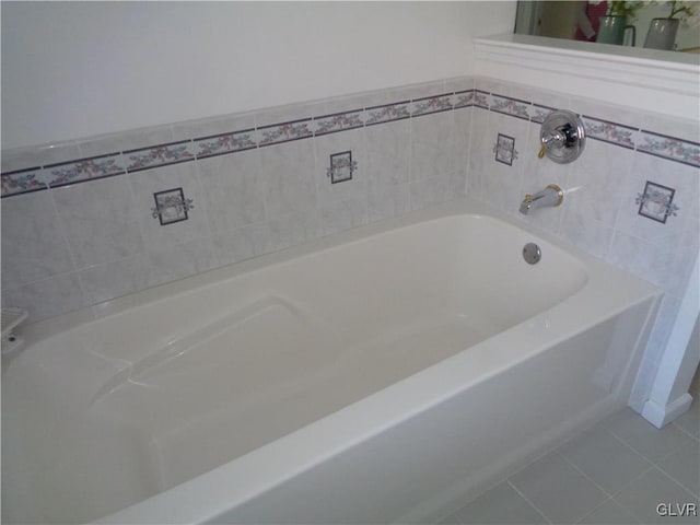 bathroom featuring a tub to relax in and tile patterned floors