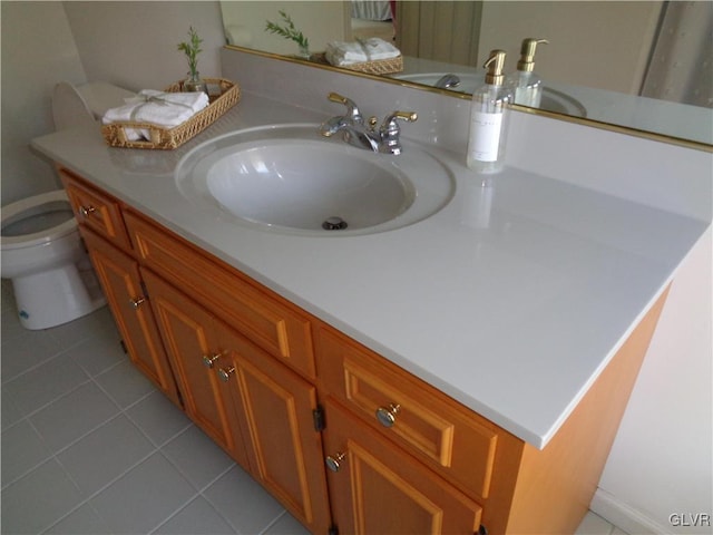 bathroom featuring vanity, toilet, and tile patterned floors