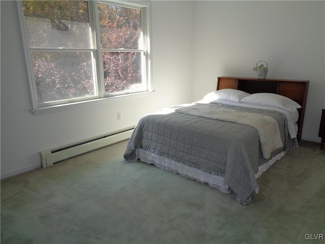 bedroom with a baseboard heating unit and carpet flooring