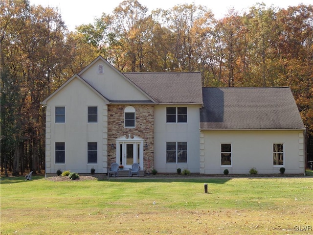 144 Dogwood Dr, Penn Forest Township, PA 18229 - view of front of property with a front lawn, roof with shingles, and stucco siding