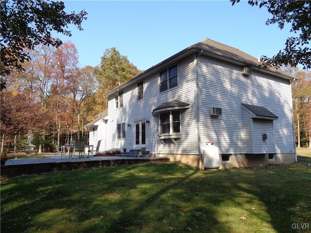 rear view of property with a yard