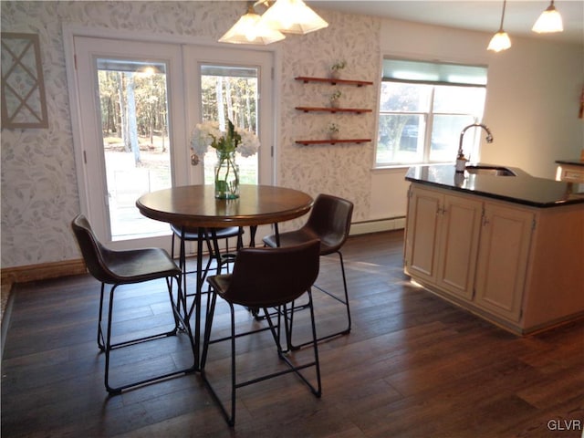 144 Dogwood Dr, Penn Forest Township, PA 18229 - dining area featuring wallpapered walls, a baseboard heating unit, dark wood-type flooring, and baseboards