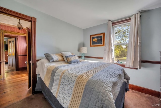 bedroom with hardwood / wood-style flooring