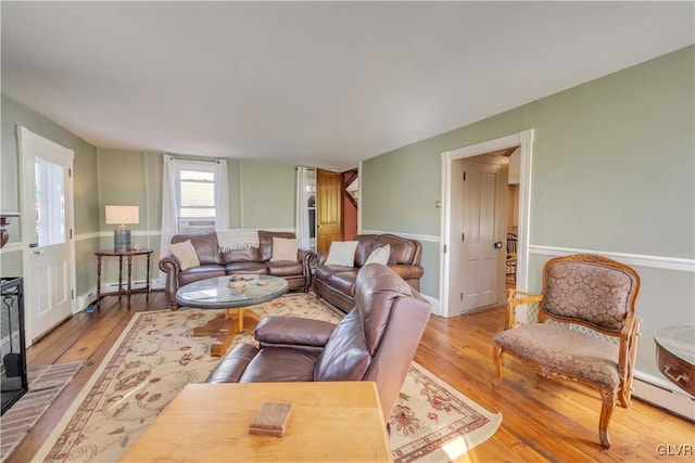 living room with light hardwood / wood-style floors and a baseboard heating unit