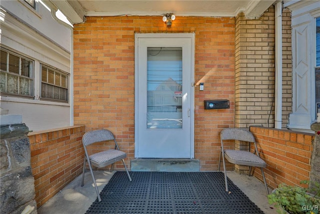 view of exterior entry featuring a patio area