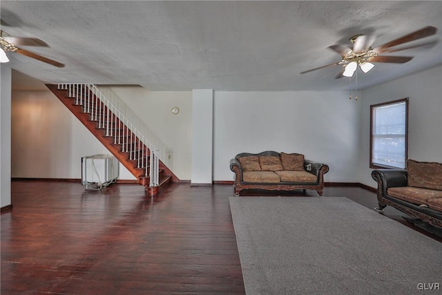 living room featuring a textured ceiling, ceiling fan, radiator heating unit, and dark hardwood / wood-style flooring