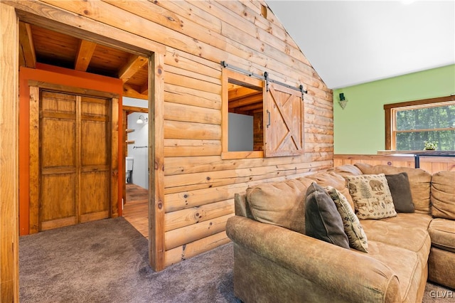 living room with lofted ceiling, a barn door, dark carpet, and wooden ceiling