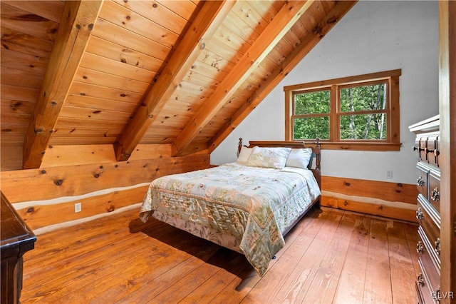 bedroom with wood-type flooring, vaulted ceiling with beams, and wooden ceiling