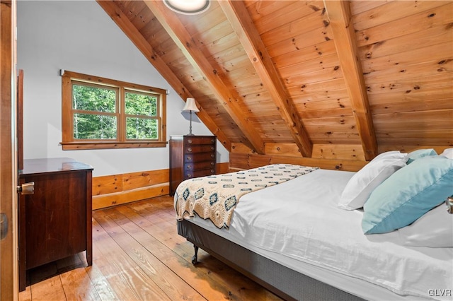 bedroom featuring lofted ceiling with beams, wood ceiling, and light hardwood / wood-style flooring