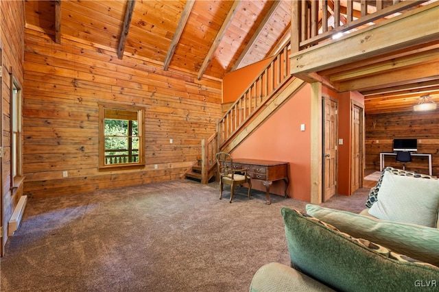 living room featuring wood ceiling, beamed ceiling, carpet, and wooden walls