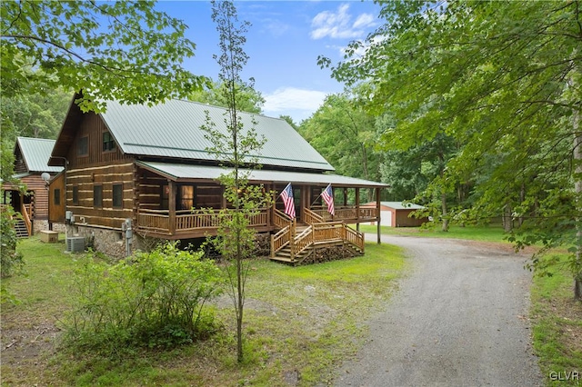 log home featuring an outbuilding and a wooden deck