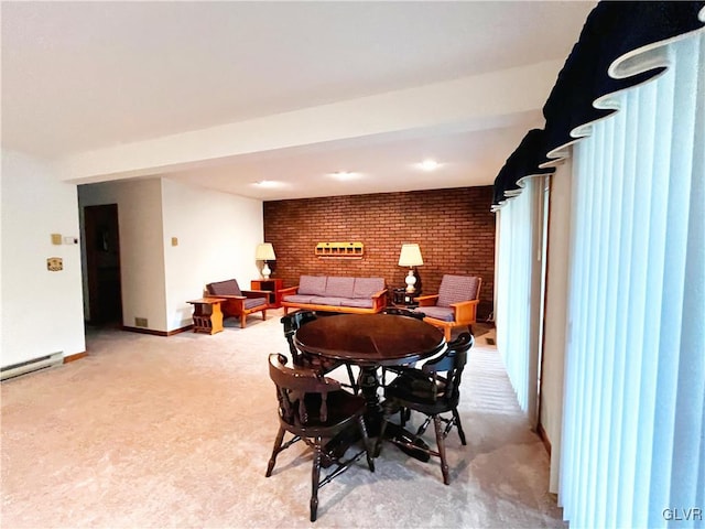 dining space with light carpet, a baseboard radiator, and brick wall