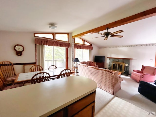 living room with lofted ceiling with beams, ceiling fan, and light colored carpet