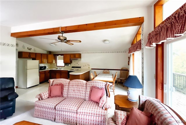 living room with vaulted ceiling with beams and ceiling fan