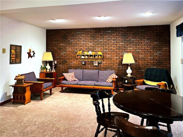 carpeted living room featuring brick wall