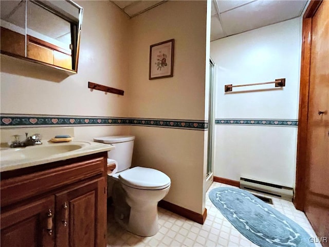 bathroom with an enclosed shower, baseboard heating, vanity, and toilet