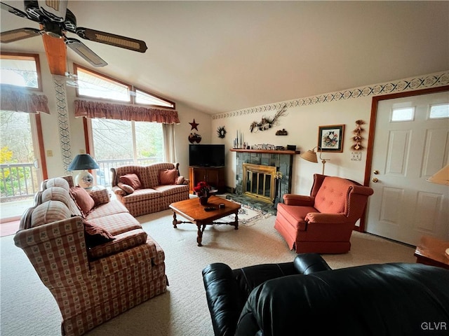 carpeted living room with lofted ceiling, a fireplace, and ceiling fan