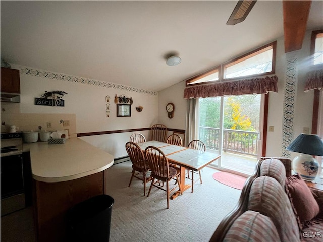 dining room with baseboard heating, vaulted ceiling, and light carpet