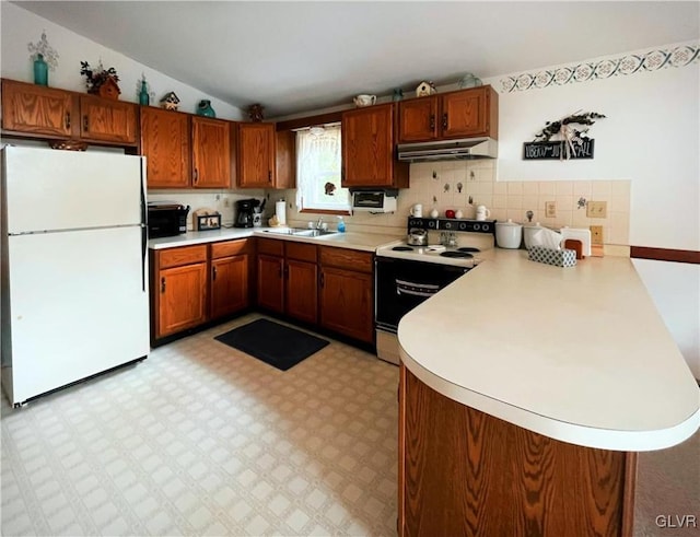 kitchen featuring kitchen peninsula, vaulted ceiling, white appliances, and sink