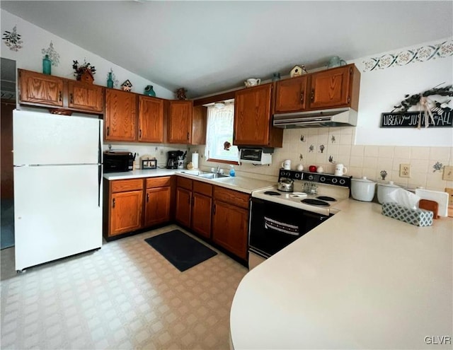 kitchen with vaulted ceiling, white appliances, and sink