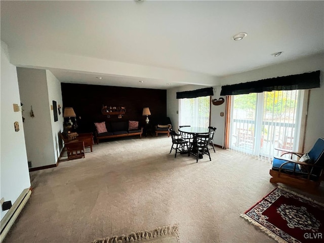 carpeted dining area featuring baseboard heating