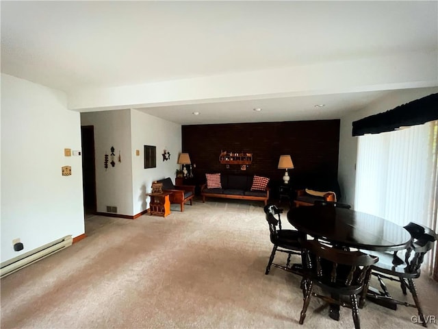 carpeted dining space with baseboard heating