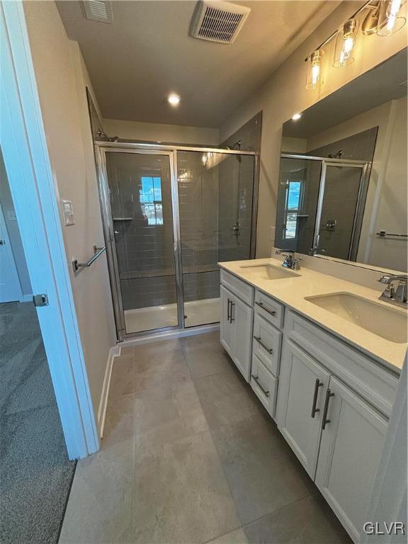 bathroom featuring vanity and a shower with shower door