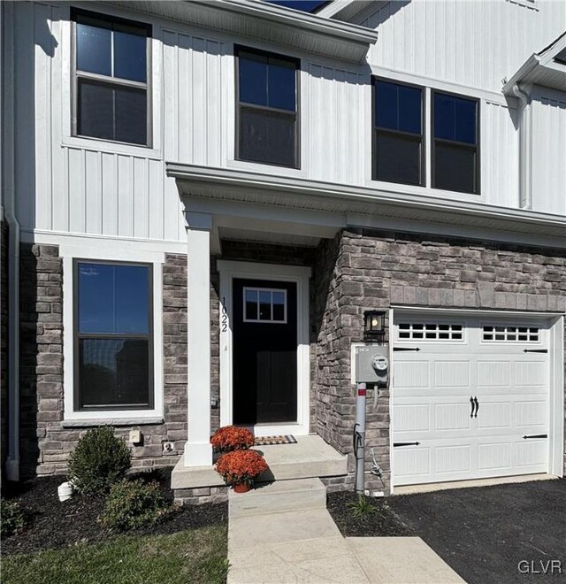 doorway to property with a garage